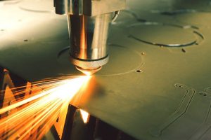 A laser die-cutter cutting through a metal sheet